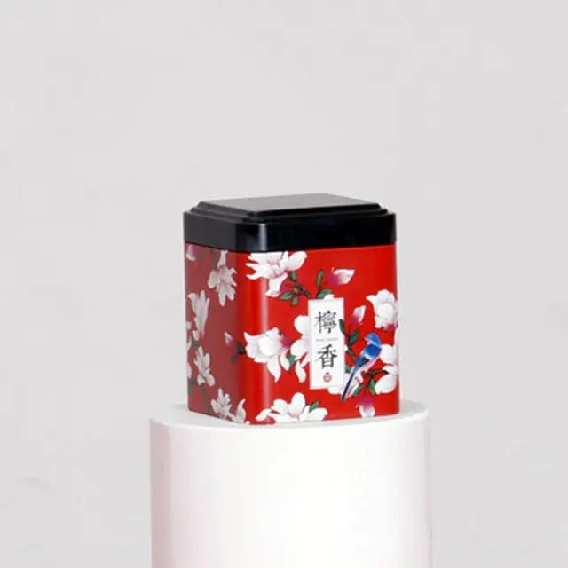Boîte à thé métal rouge avec fleurs blanches