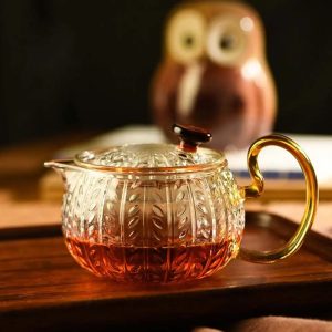 Théière en verre élégante avec motifs décoratifs