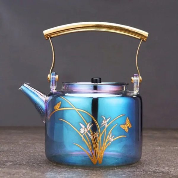 Théière en verre coloré avec motifs de papillons